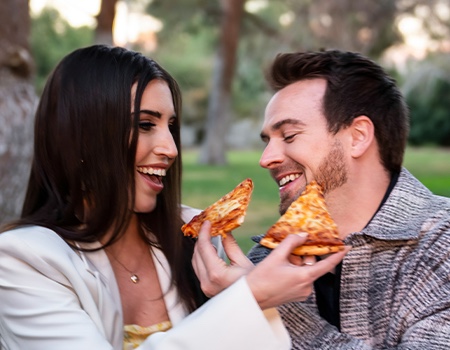 stop-wasting-time Couple feeding each other pizza